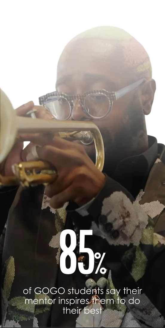 Man with bleach blond and pink hair, wearing round glasses and a dark floral jacket, playing a trumpet, with text stating 85% of GOGO students say their mentor inspires them to do their best.